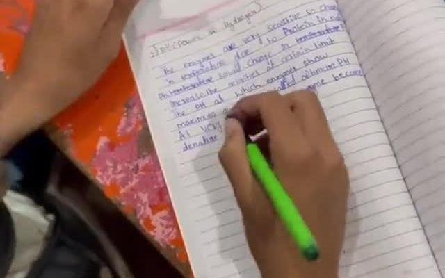 Student writing notes